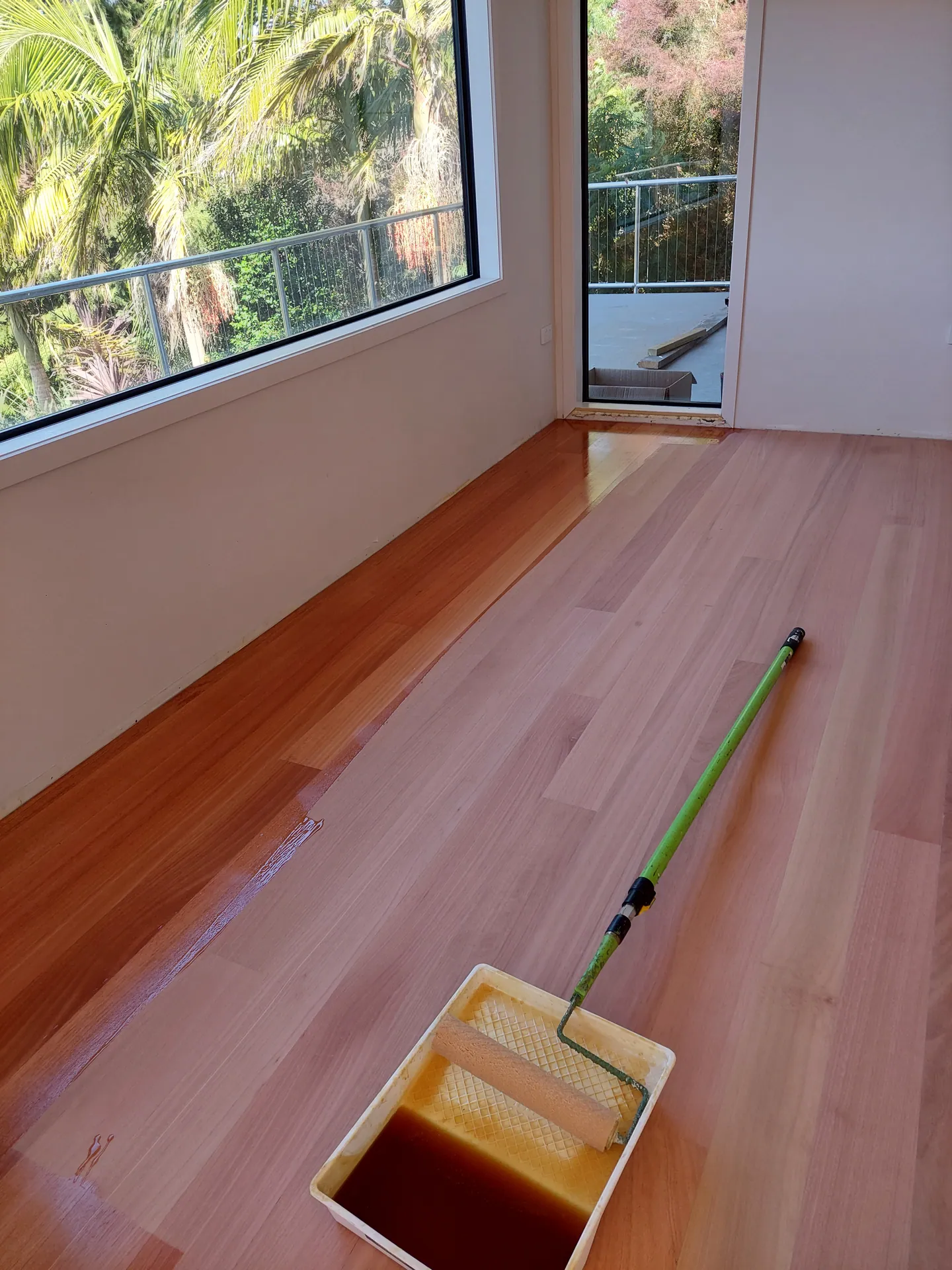 Coating a freshly sanded floor.