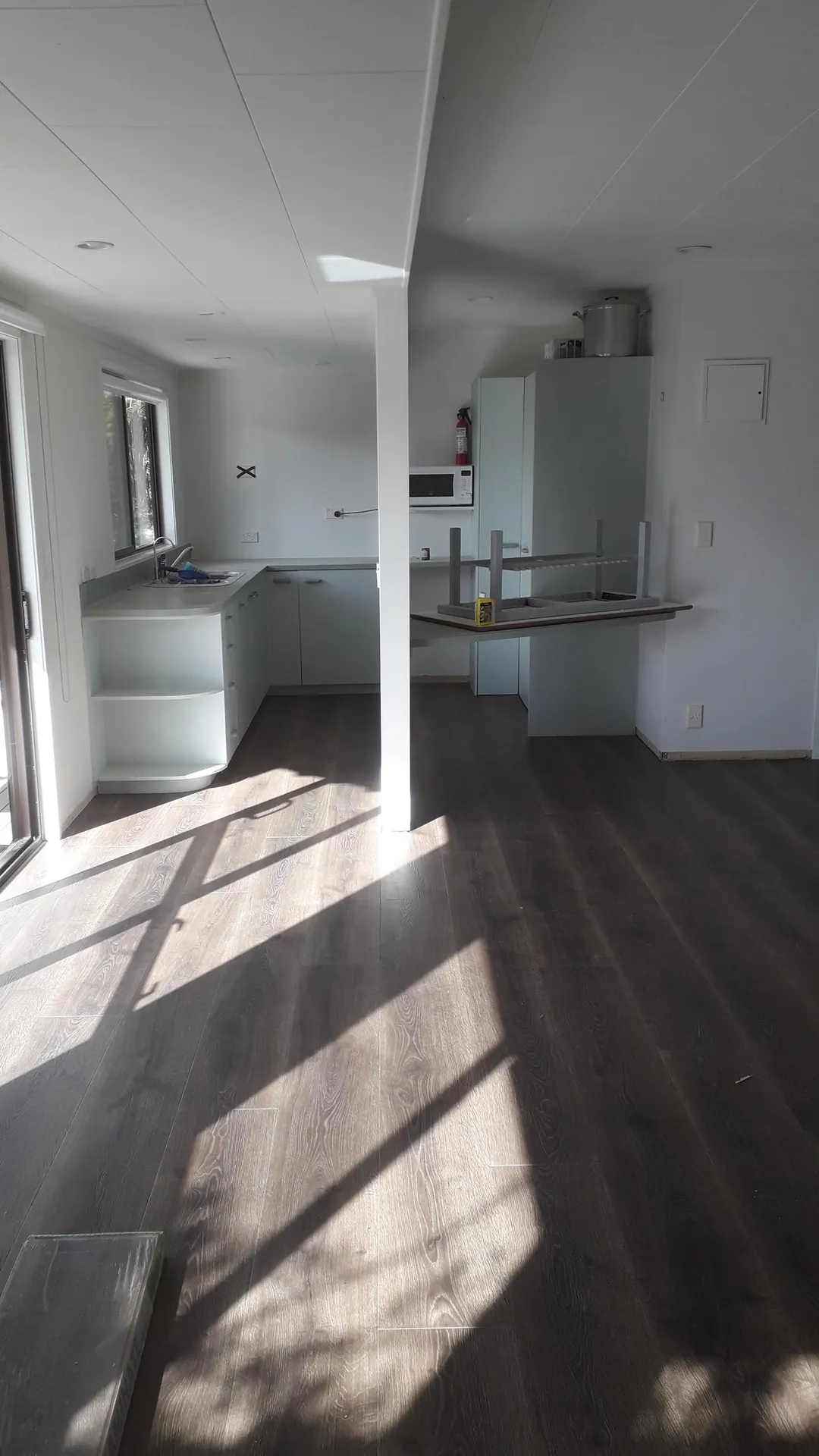 Dark grey floor in a sunny kitchen.