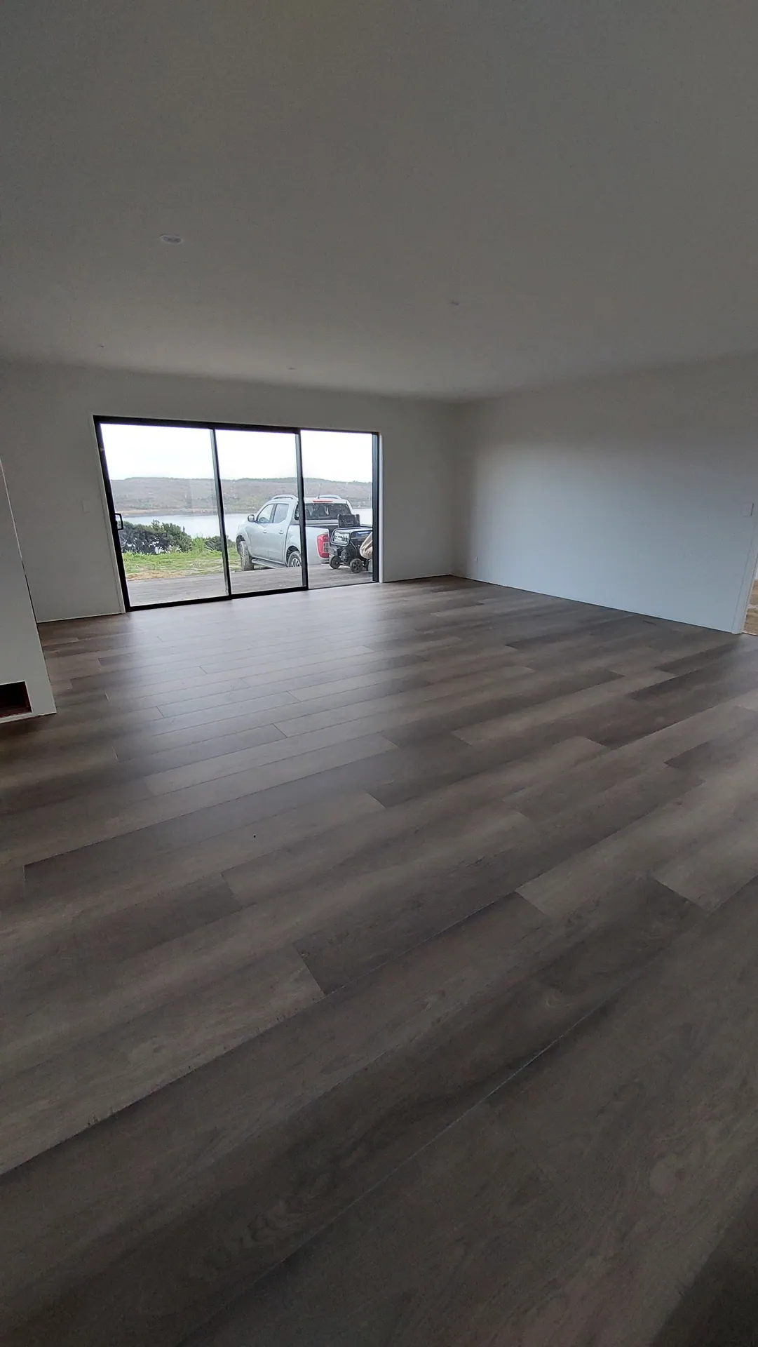 Dark grey floor in an empty living room.