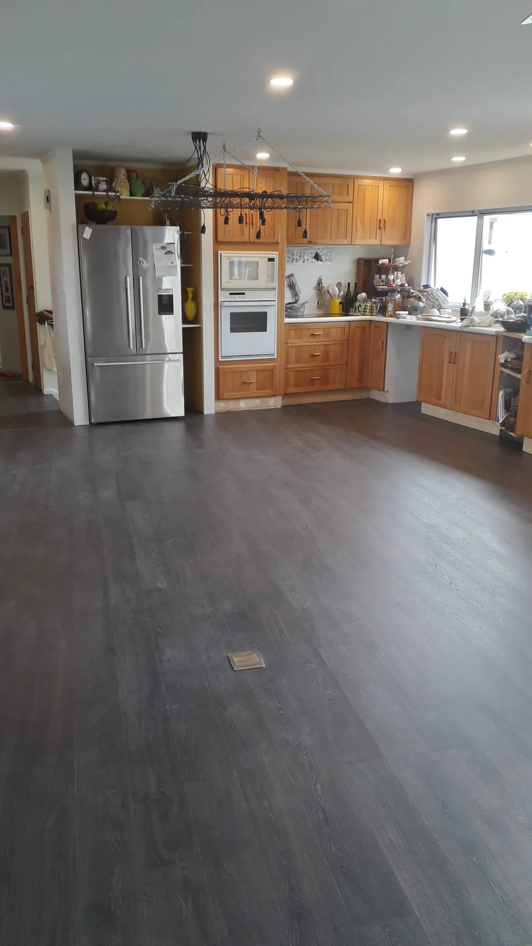 Dark grey floor through an open-plan kitchen.