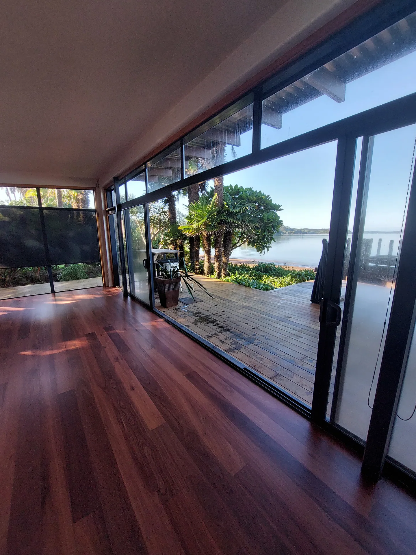 Dark timber floor by big windows to the harbour.