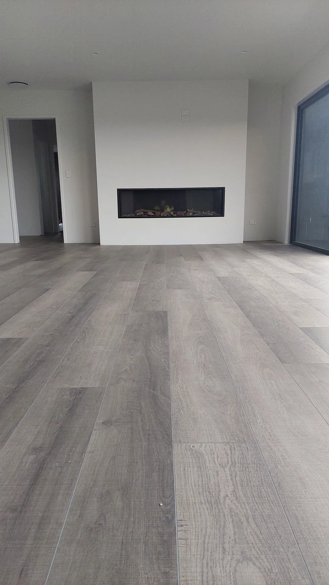 Grey floor by a modern fireplace.