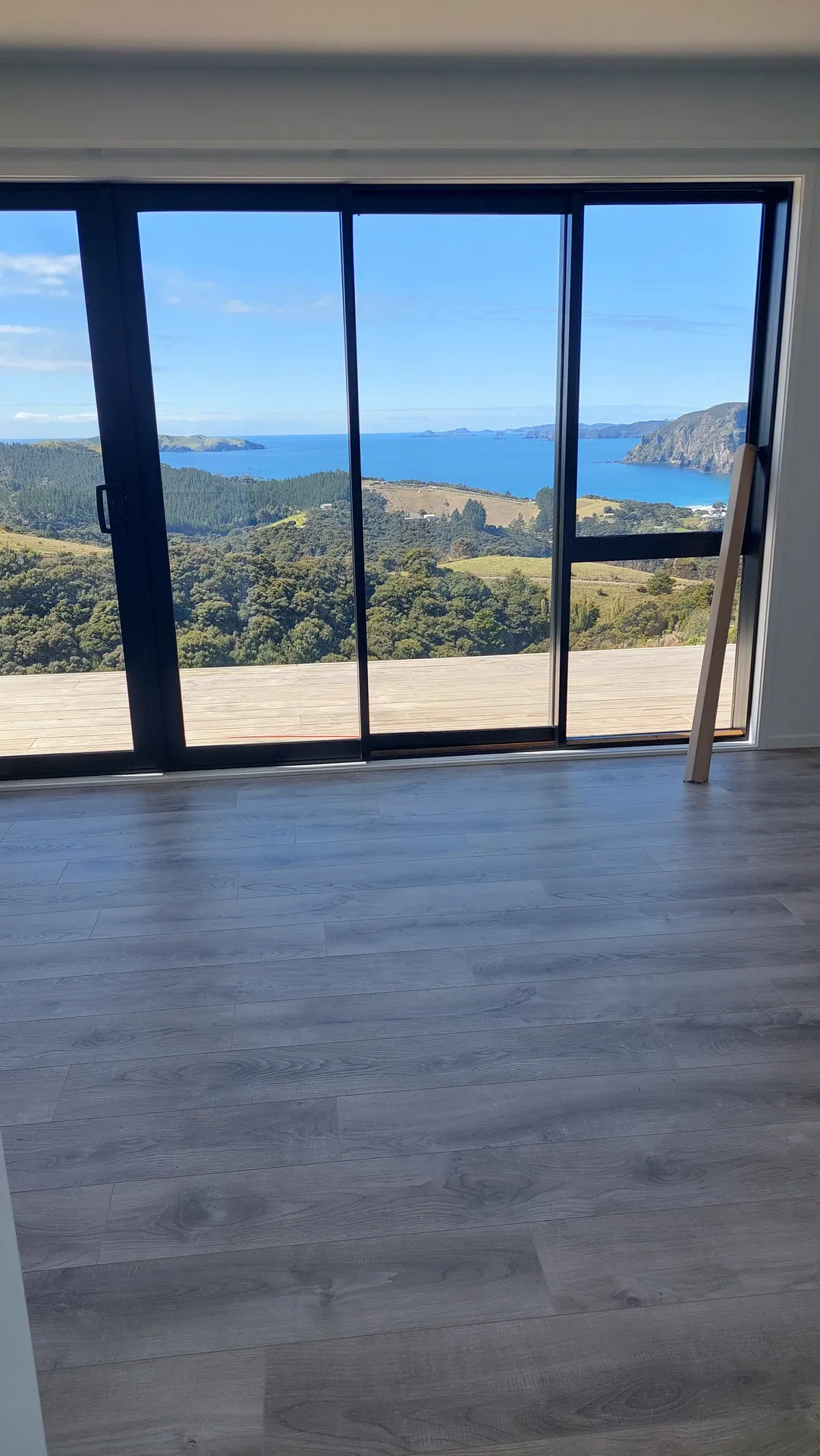 Grey floor facing a sea view.