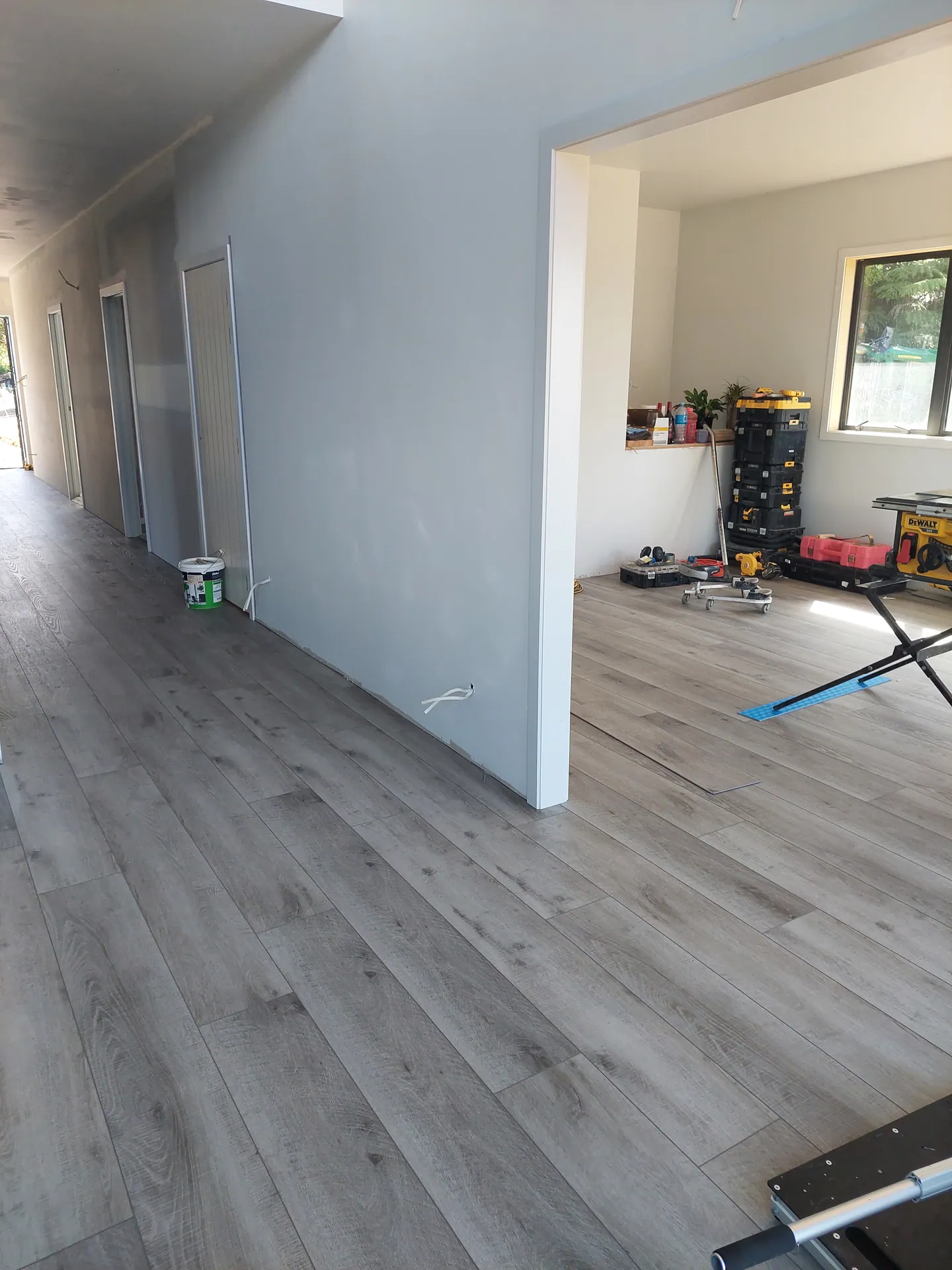 Grey floor going down in a hallway.