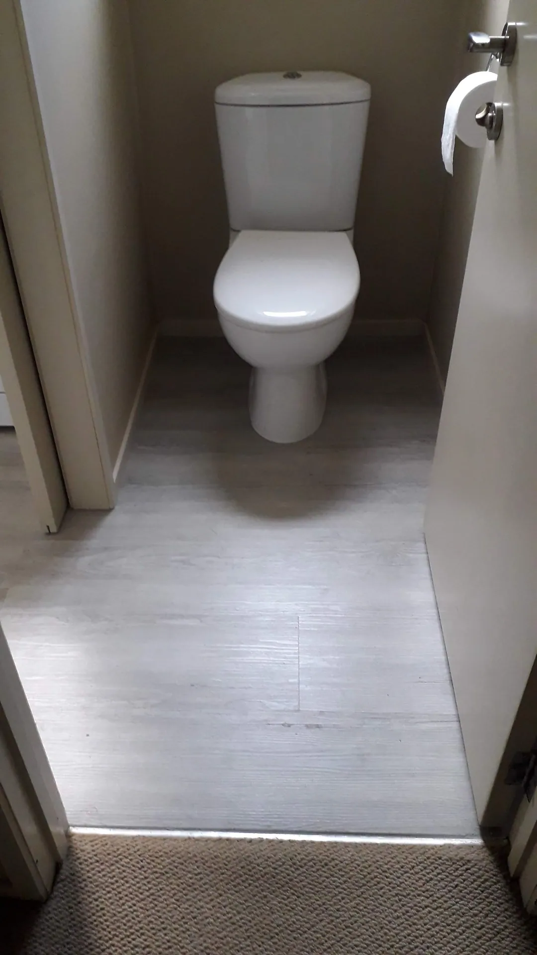Grey floor in a toilet.