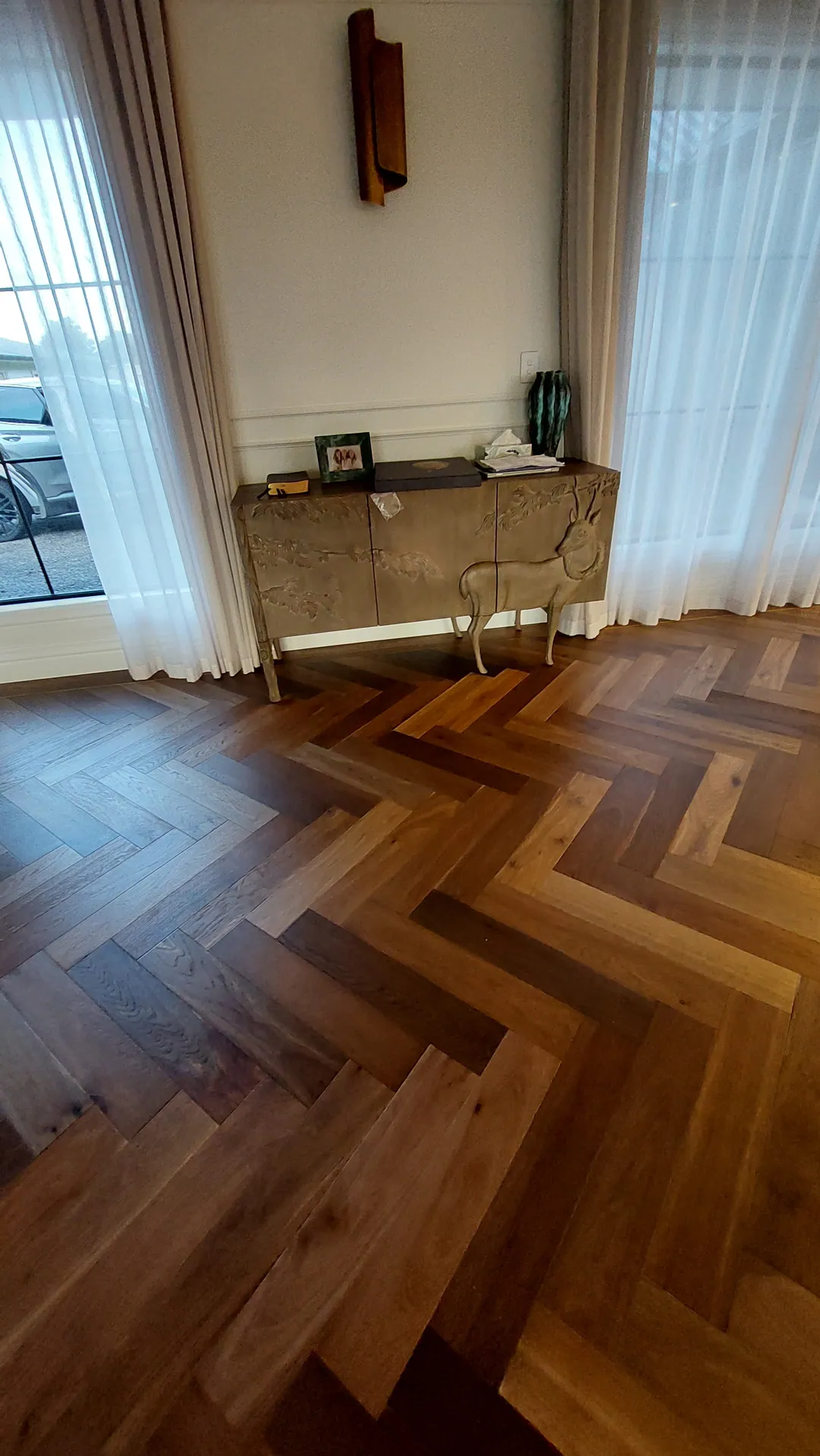 Herringbone oak by sheer curtains.