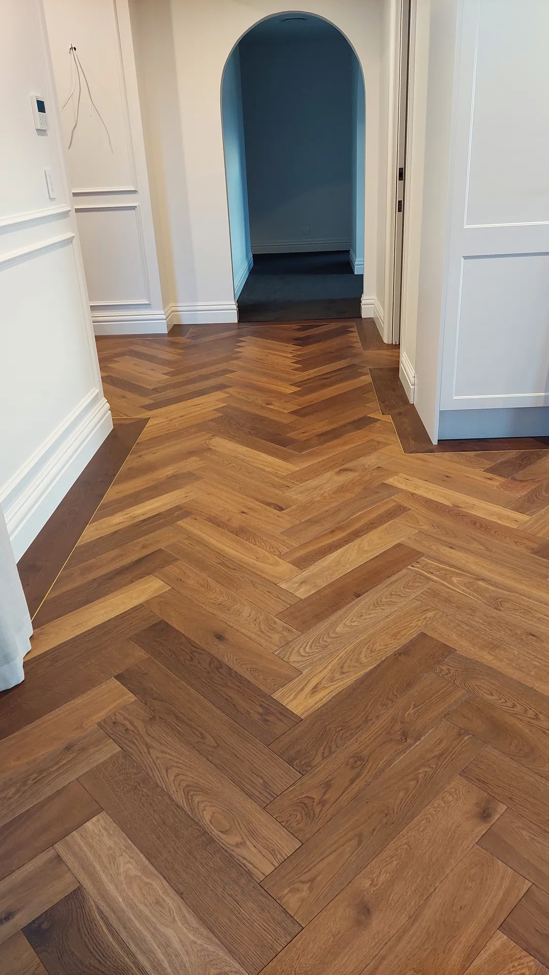 Herringbone oak to an arched doorway.