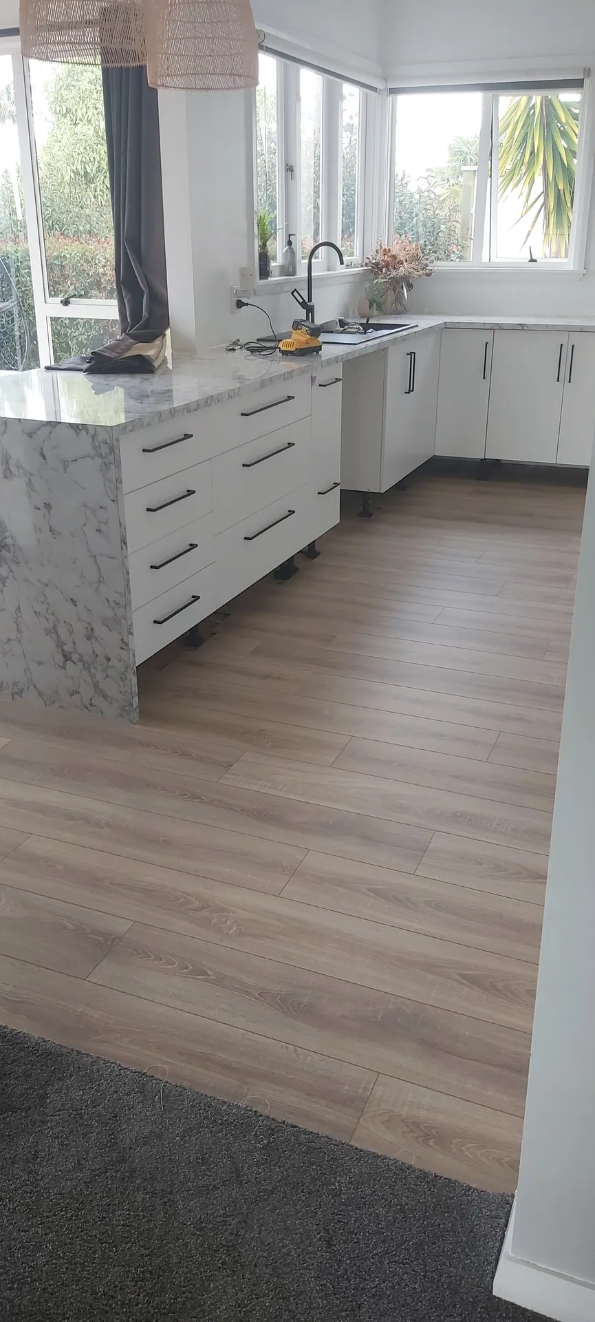 Light floor in a white kitchen.