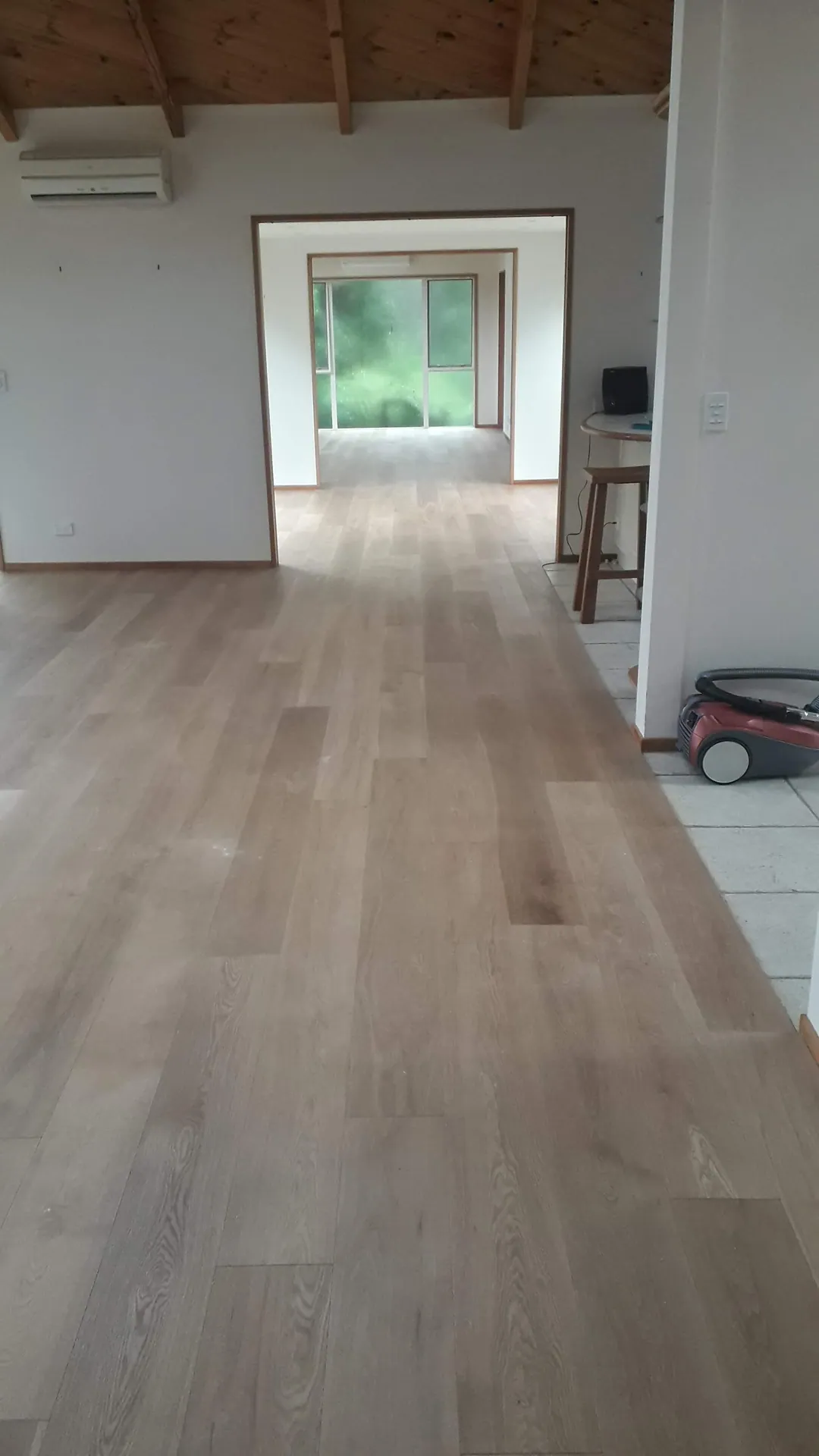 Light grey floor through a long open room.