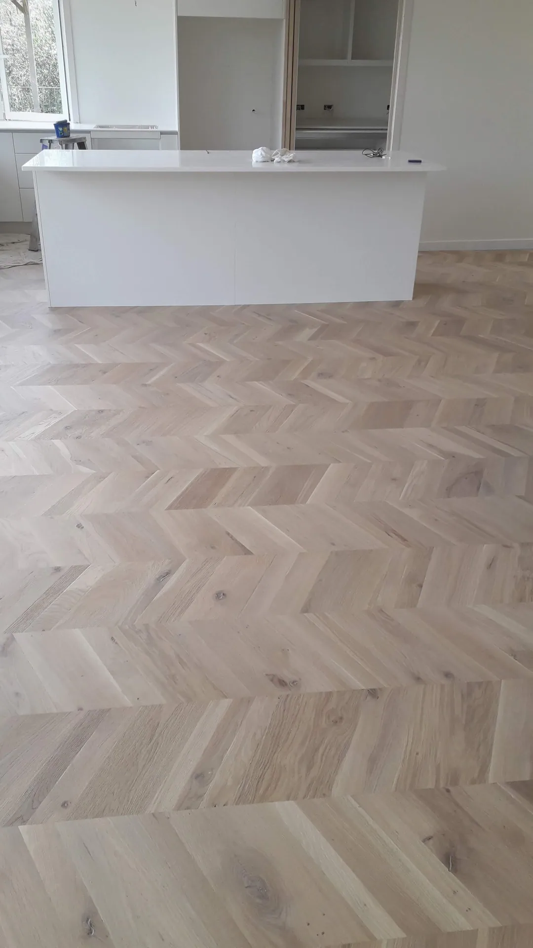 Light oak herringbone floor in a kitchen.