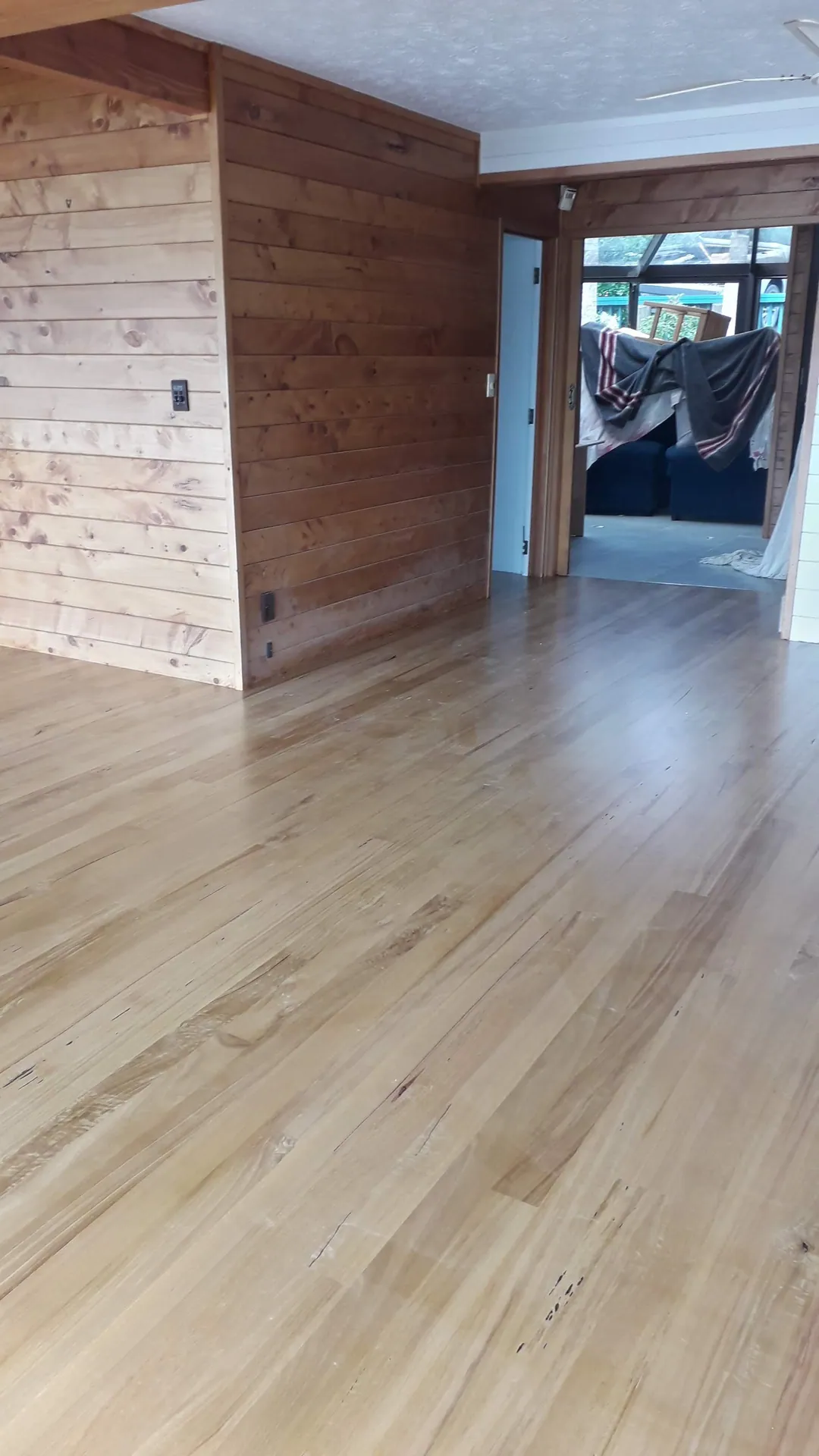 Light timber floor beside a cedar-lined wall.