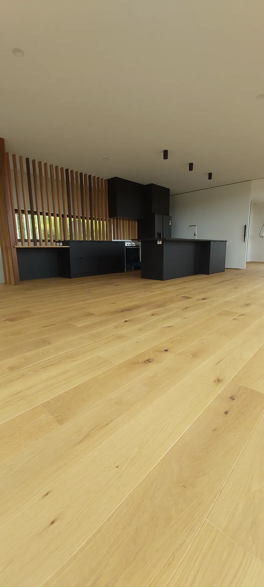 Long light oak floor in a modern open-plan room.