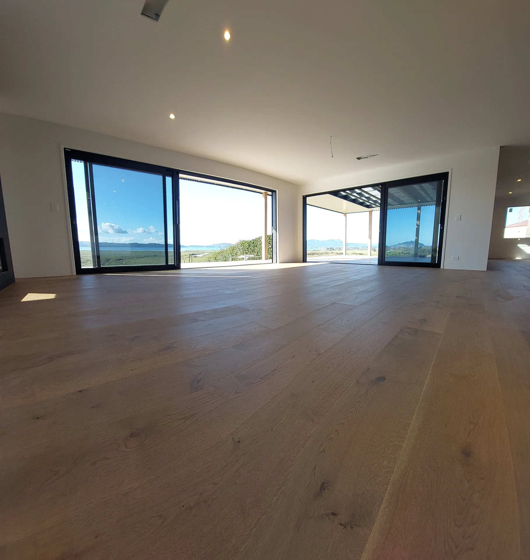 Oak floor facing big windows and the water.