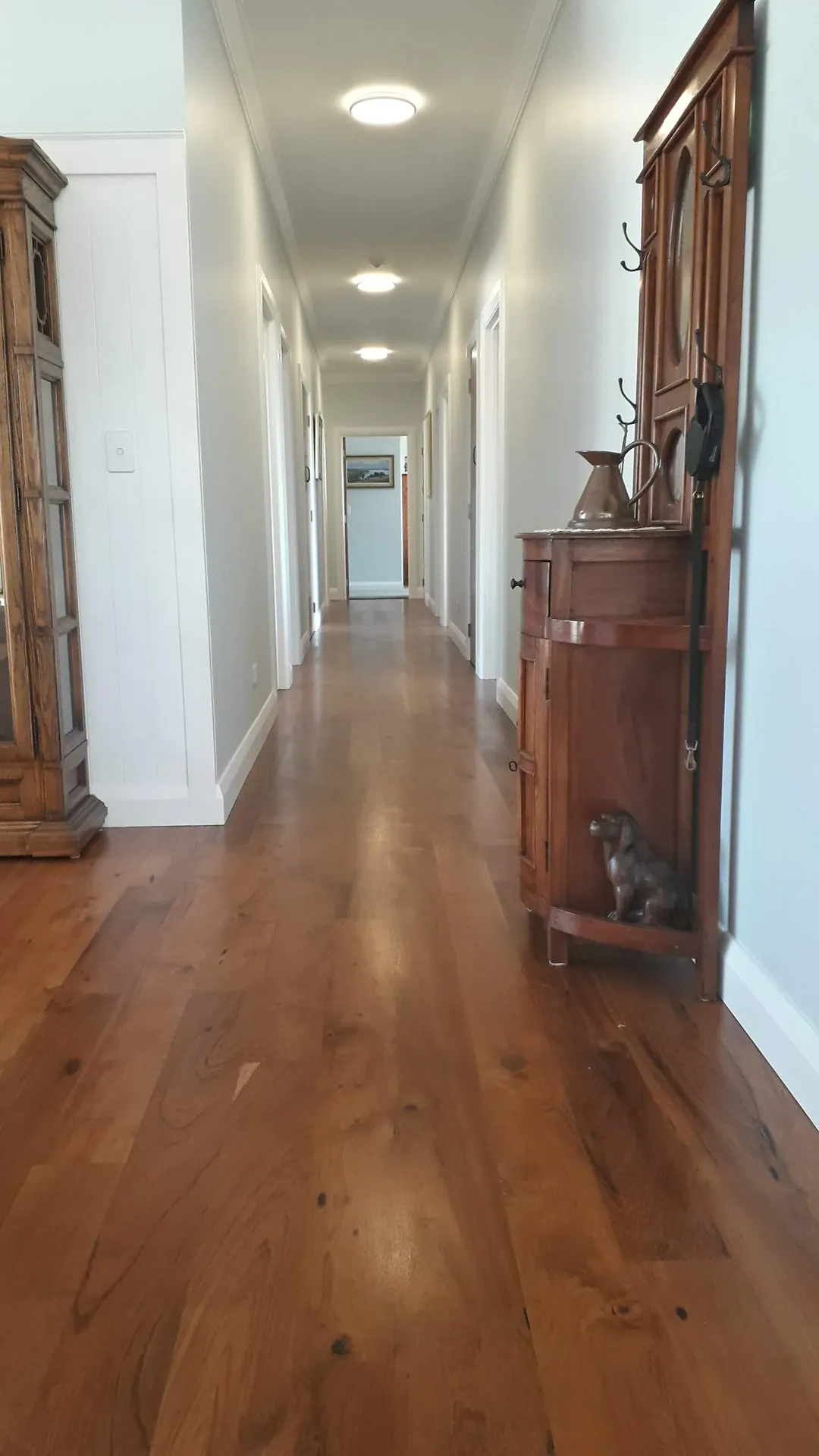 Rich timber floor down a long hallway.