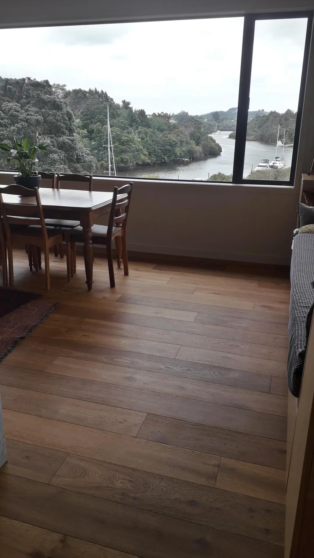 Timber floor in a dining room with a river view.