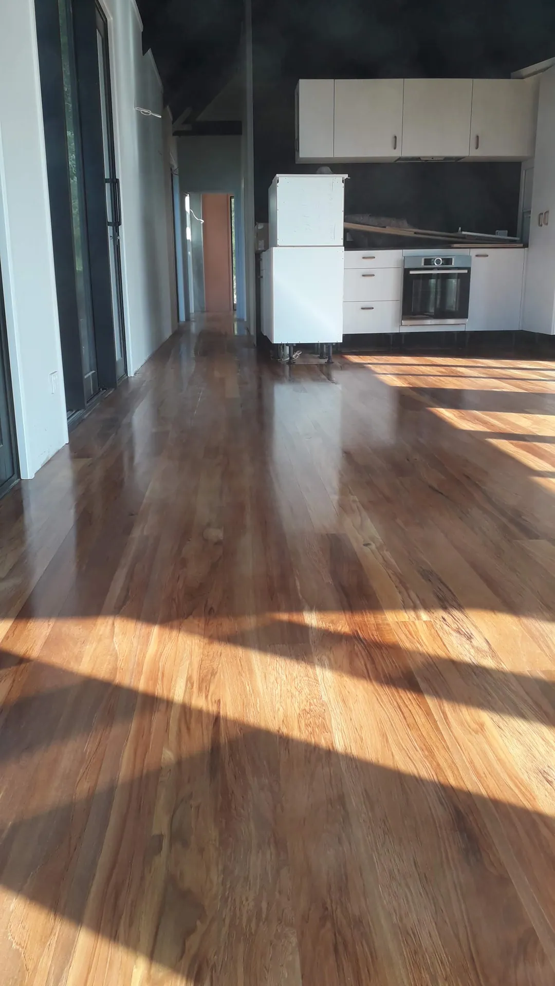Timber floor through an open-plan kitchen.