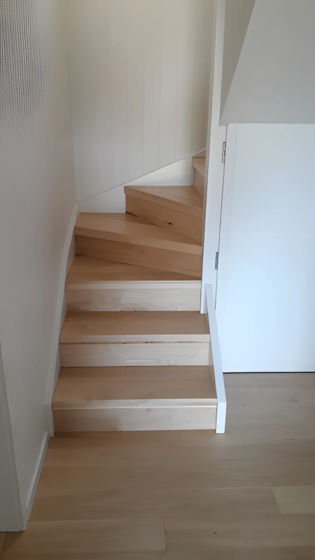 Timber stairs with a turn at the bottom.