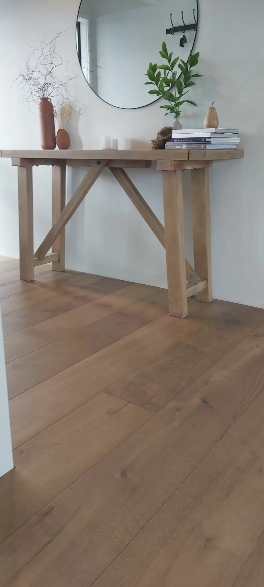 Wide oak floor in an entry.
